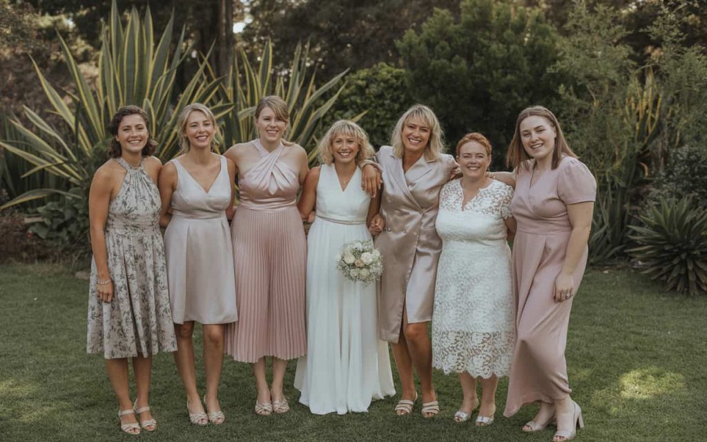 Diverse group of mothers of the bride in Australia showing different body types and styles, smiling at an outdoor wedding.”